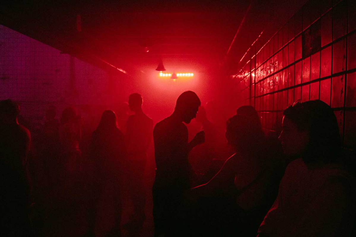 A group of people dancing in a dark room