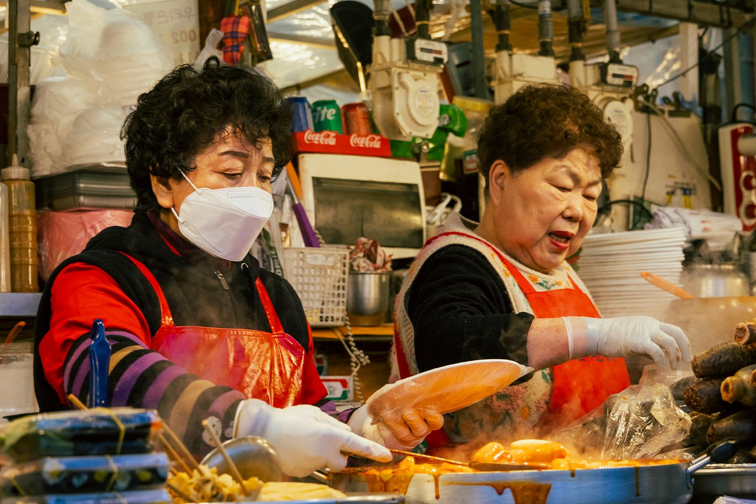 South Korean women cooking in a Seoul food market