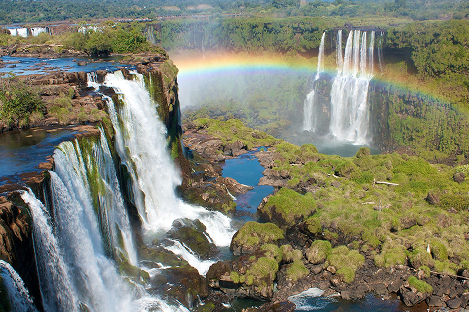 See a dazzling rainbow over the world's largest waterfall, Iguazú Falls