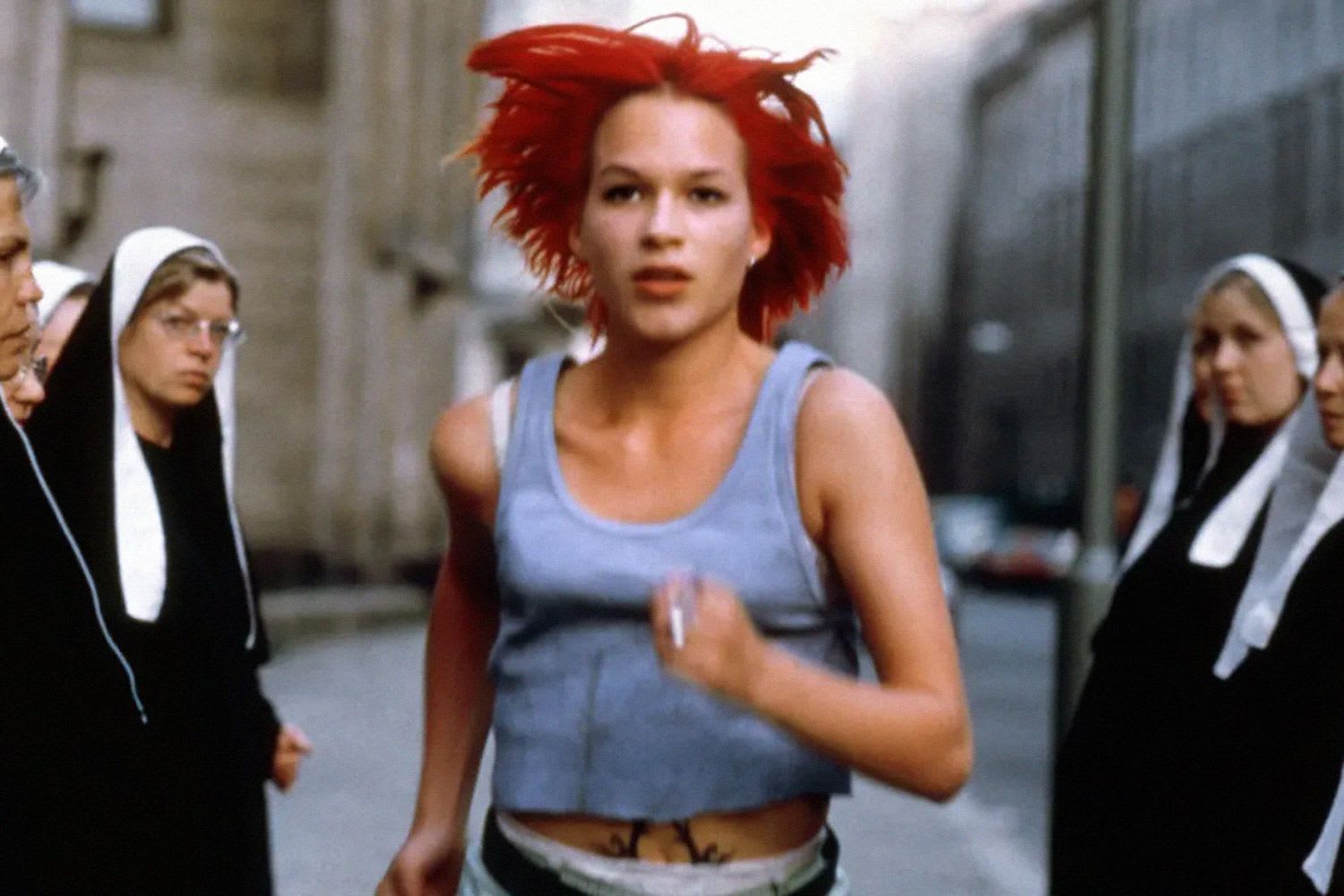 Red-haired person running with 'Wooness' logo