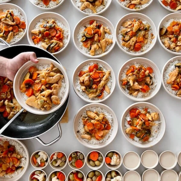 Bowls of rice with chicken and vegetables