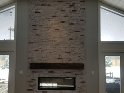 Reclaimed brick fireplace with "German schmear" technique