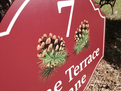 Address plaque with printed pinecones and street name. Dundas, ON.