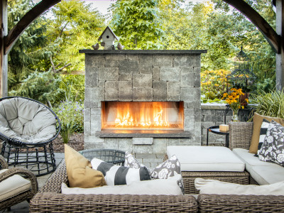 Dimensional stone gas fireplace under pavilion