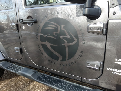 Matte black vinyl logo on Jeep door.