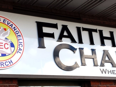 Acrylic cut letters and logo pin mounted on aluminum frame for Mississauga chapel exterior sign.