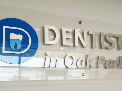 Clear acrylic sign with aluminum lettering for dental office, Oakville, On.