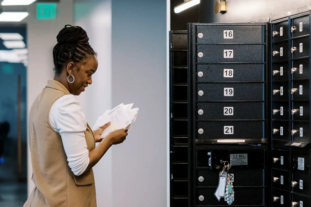 Lucid Private Offices member checking her private mailbox with numbered mail slots