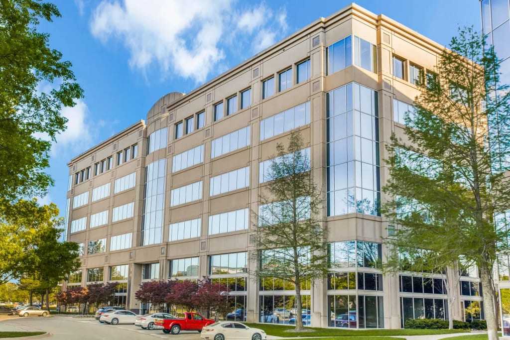 Exterior view of Lucid Private Offices Legacy Frisco building on Tennyson Parkway with trees