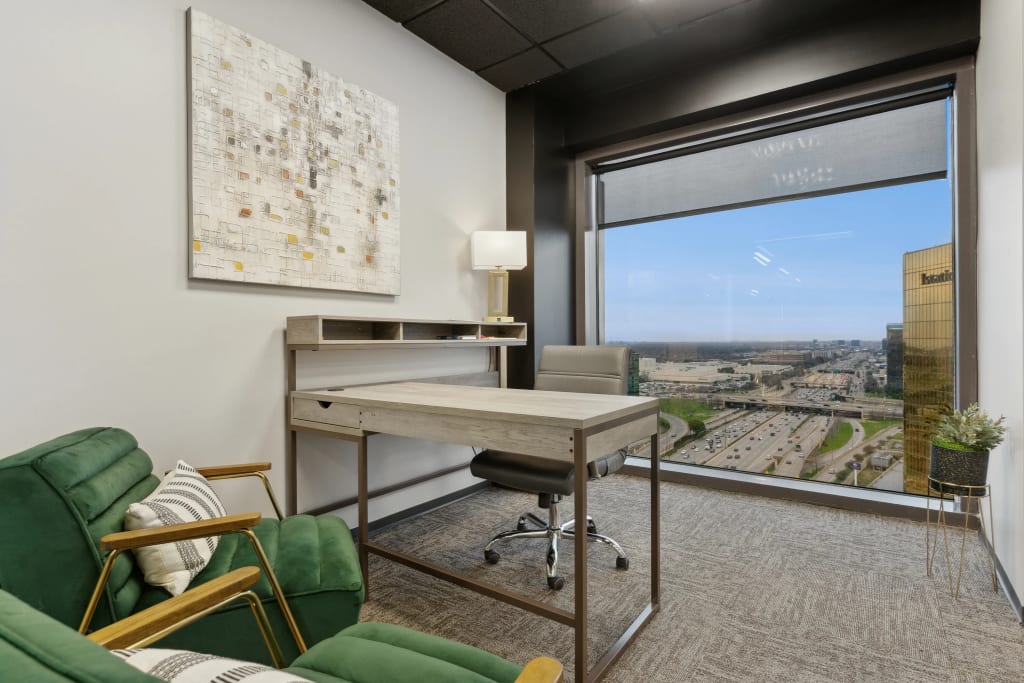 Private office with desk, chairs, artwork and city view window at Lucid Private Offices