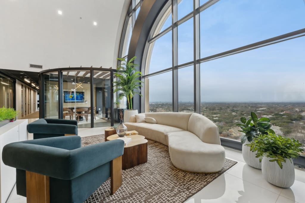 Coworking lobby with arched window and reception desk at Lucid Private Offices North Central Expressway