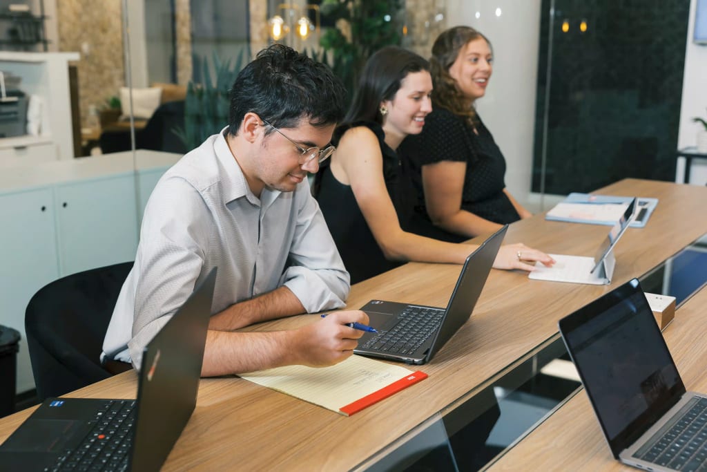 Professionals working in a collaborative workspace at Lucid Private Offices Westlake with modern office amenities.