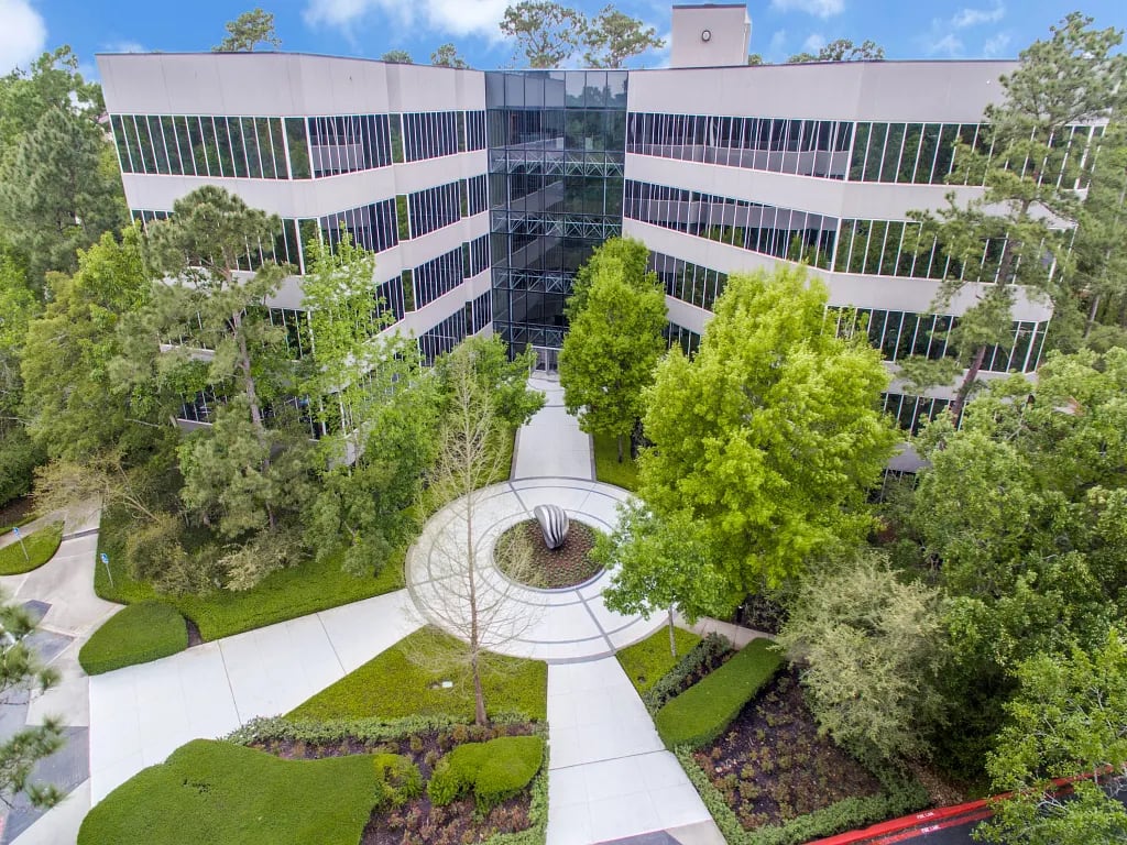 Aerial view of Lucid Private Offices The Woodlands office building surrounded by trees