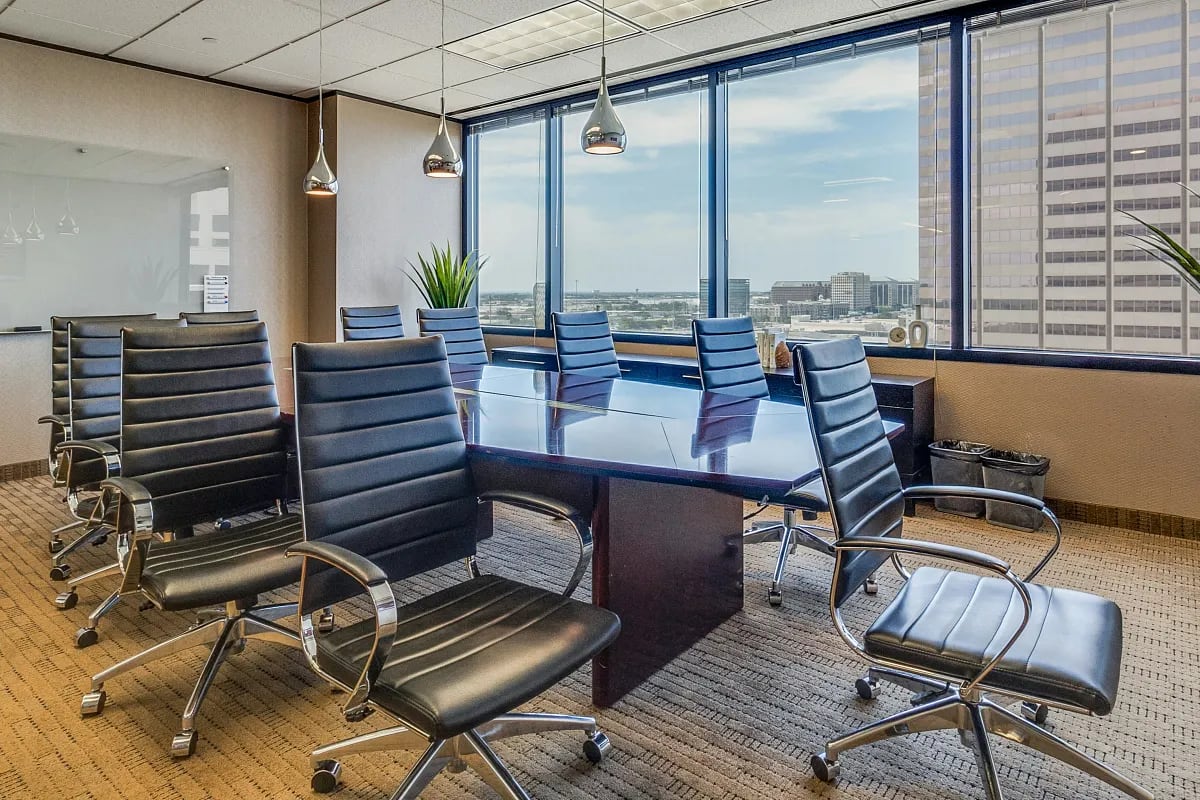 Spacious Lucid Private Offices meeting room with long conference table, leather chairs, and panoramic city views