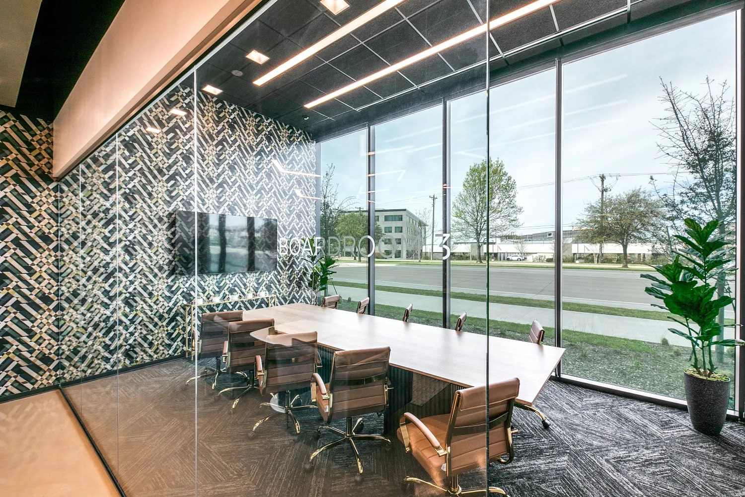Meeting room at Lucid Private Offices McKinney with conference table, chairs, and floor-to-ceiling windows