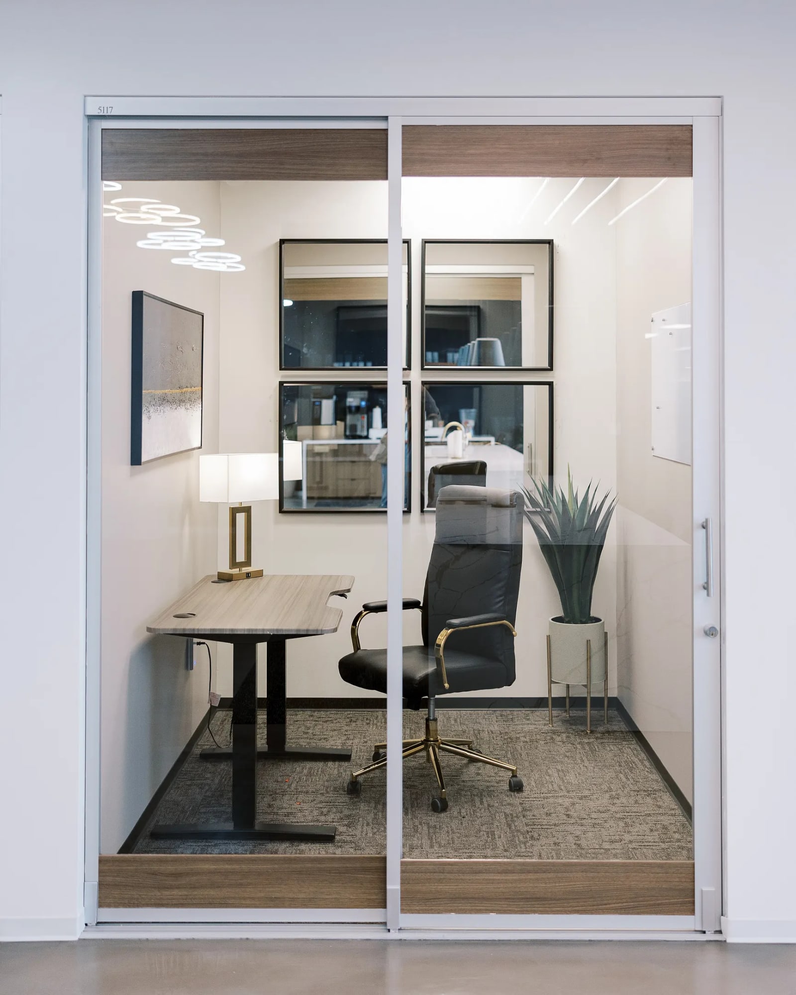 Professional at his desk in a private office with blue floral wall artwork and decor