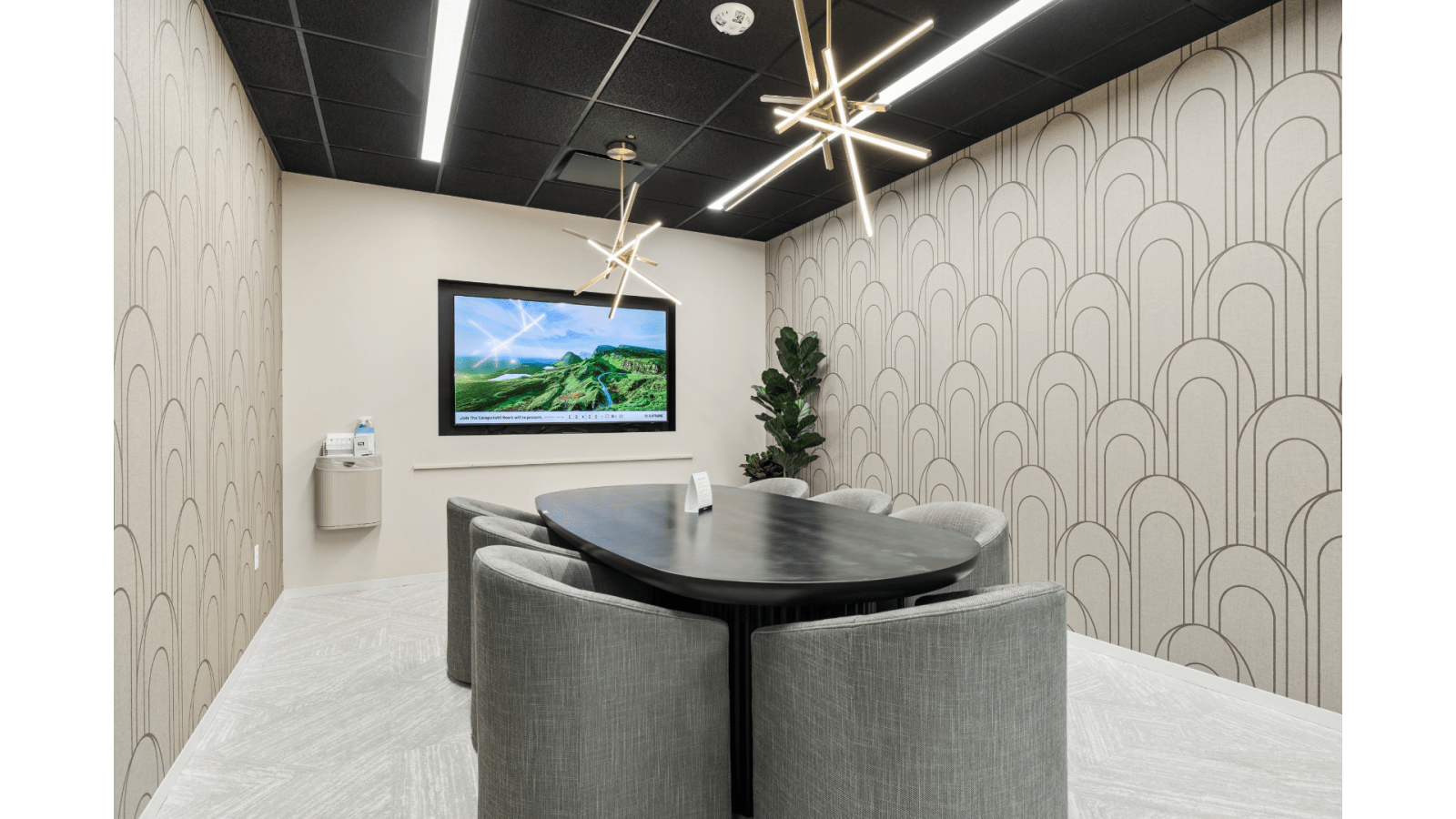 Conference room at Lucid Scottsdale/Old Town with modern seating, video display, and contemporary lighting.