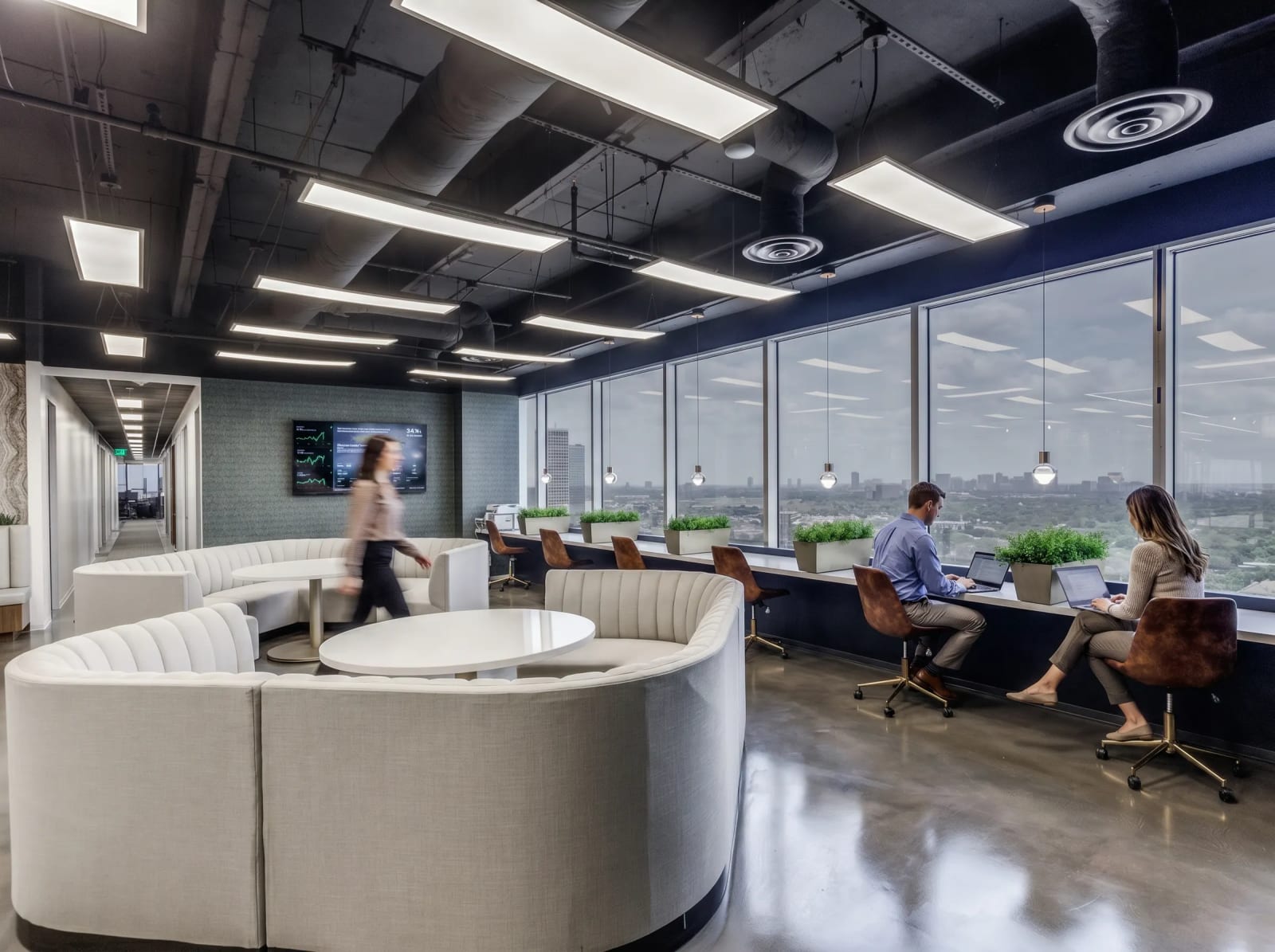 Lucid Private Offices River Oaks coworking space with curved lounge seating and open workspace