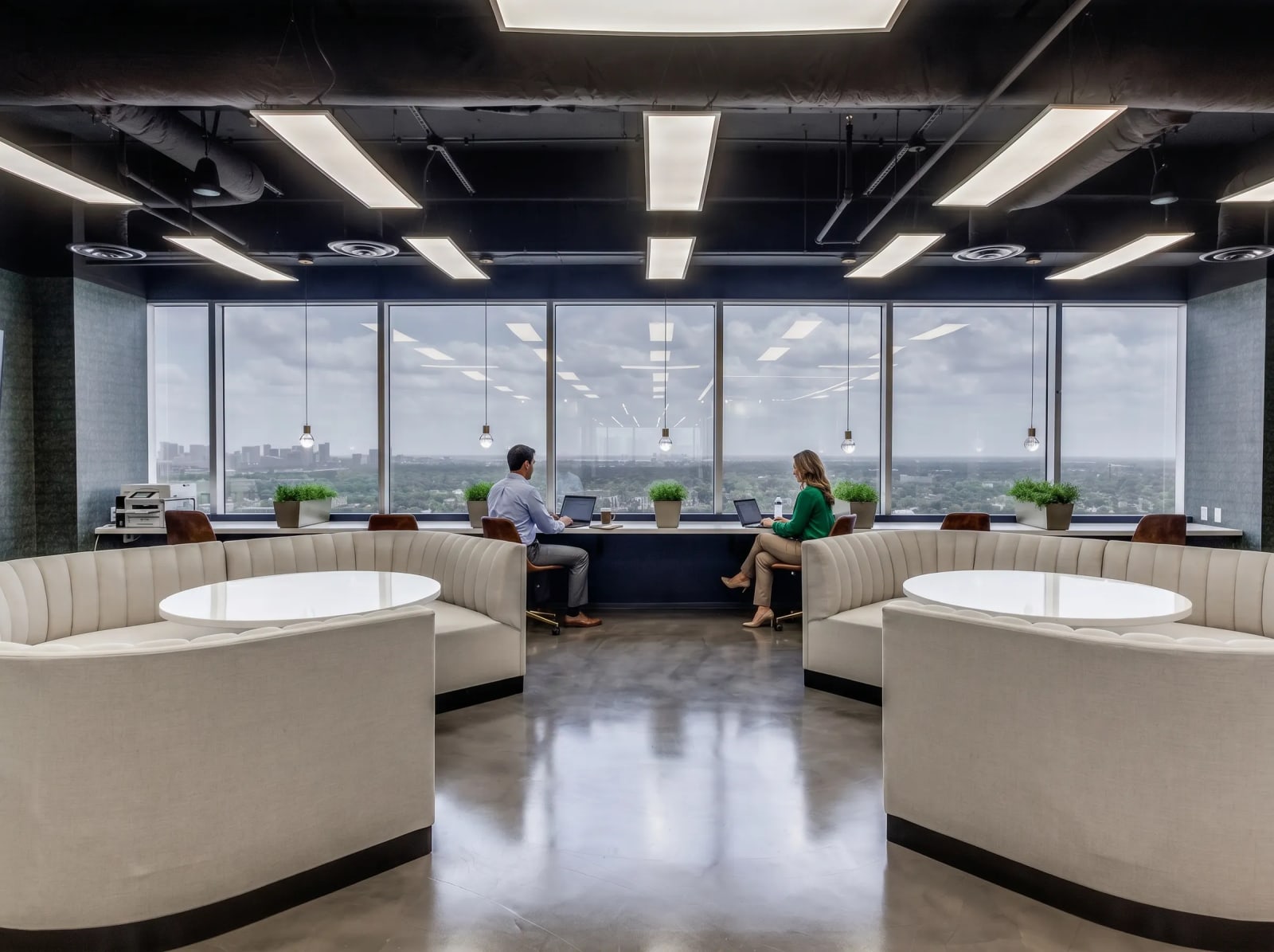 Coworking hot desk bar with long communal table at Lucid Private Offices River Oaks