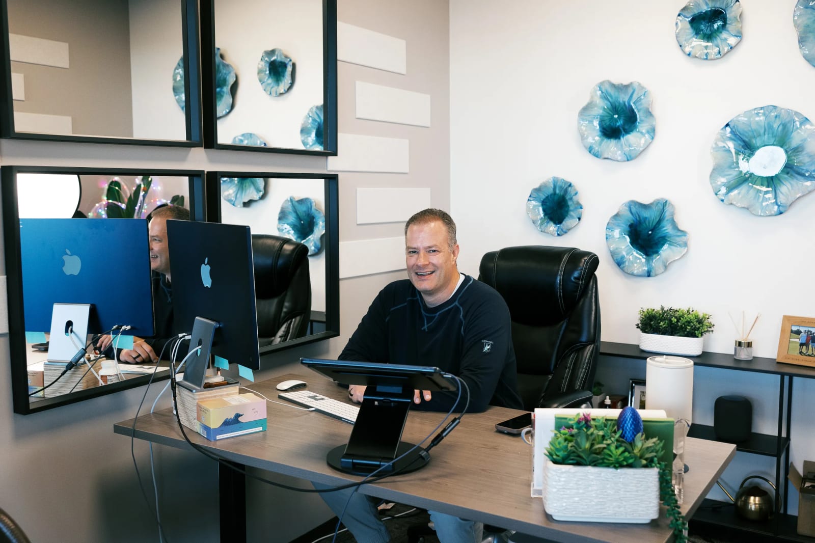 Professional working at her private office desk with bookshelf at Lucid Private Offices
