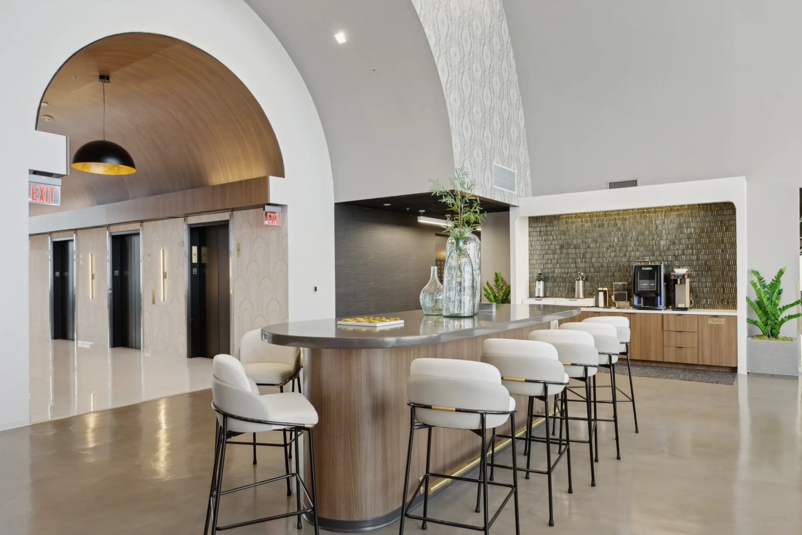Lucid Private Offices upscale lobby lounge with arched ceiling, bar seating, and coffee station