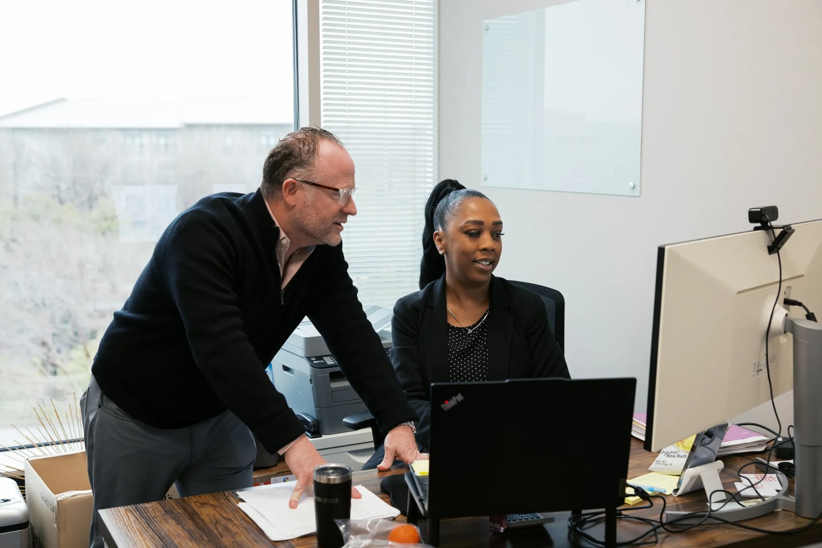 Two people working in a private office at Lucid Private Offices - Legacy / Frisco