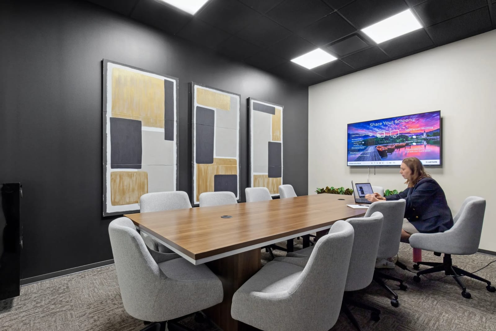 Meeting room with conference table, wall art and TV at Lucid Private Offices