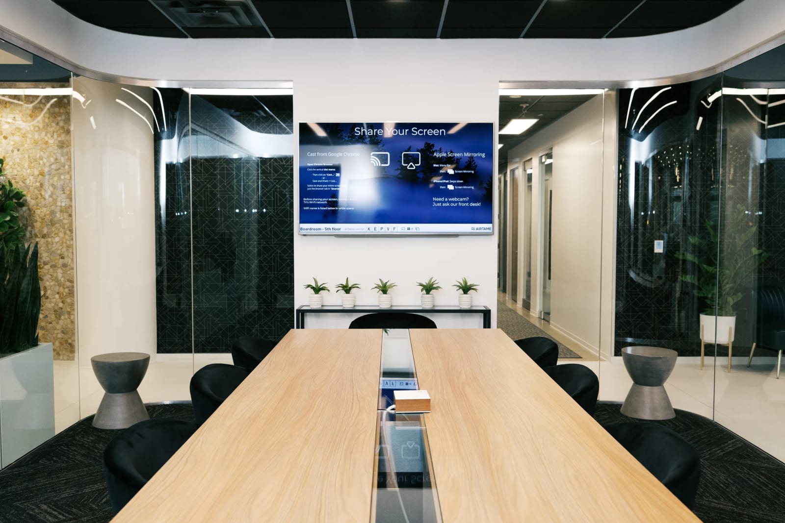Private office corridor with glass-walled offices at Lucid Private Offices Las Colinas