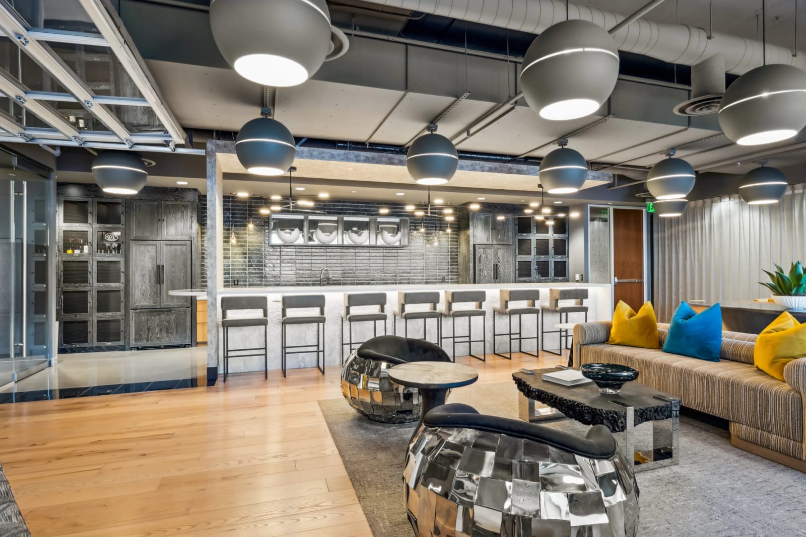 Building amenities at Lucid Private Offices Kierland featuring modern common lounge with sofas, chairs, and professional workspace