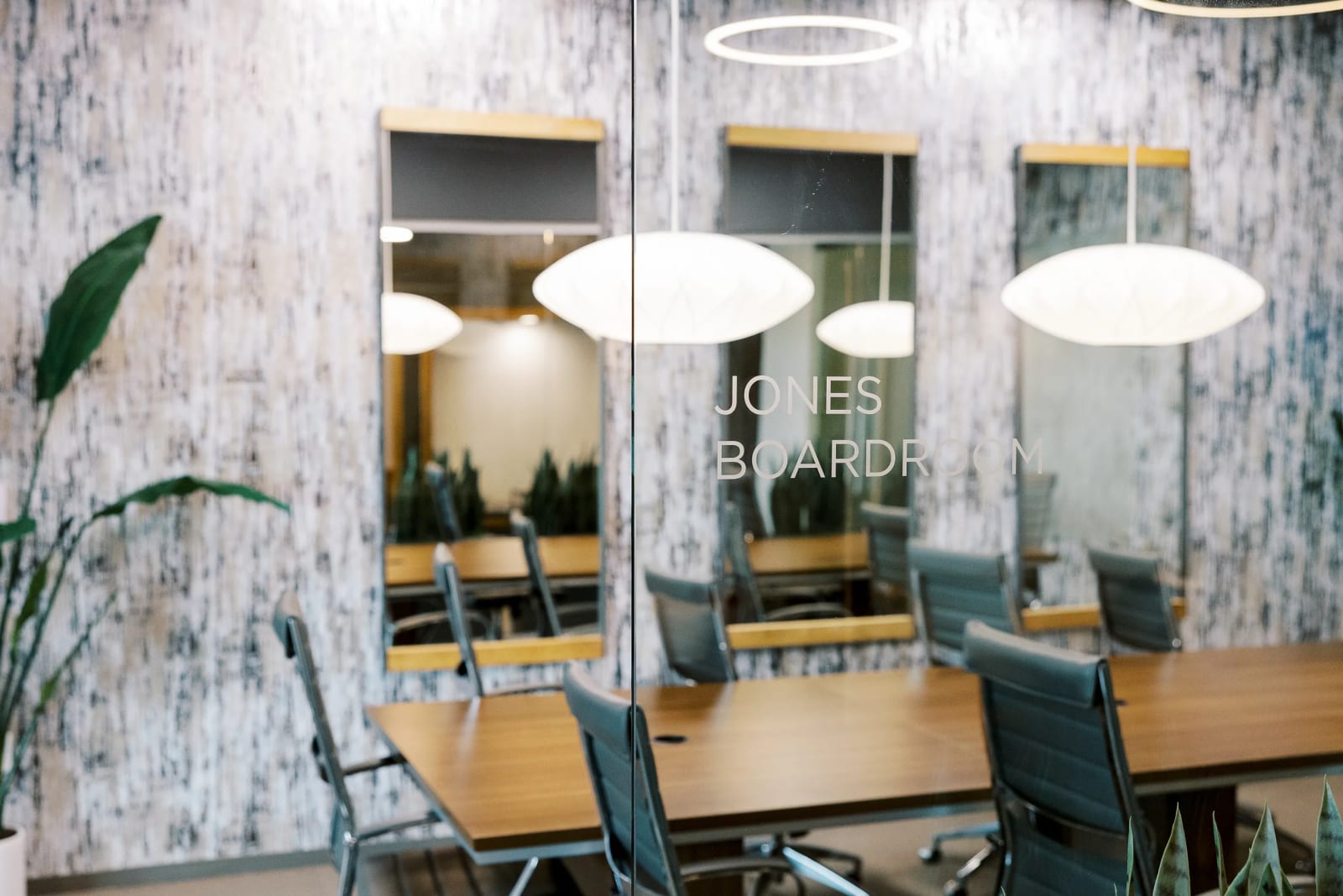 Elegant meeting room with pendant lighting and marble walls for private office meetings
