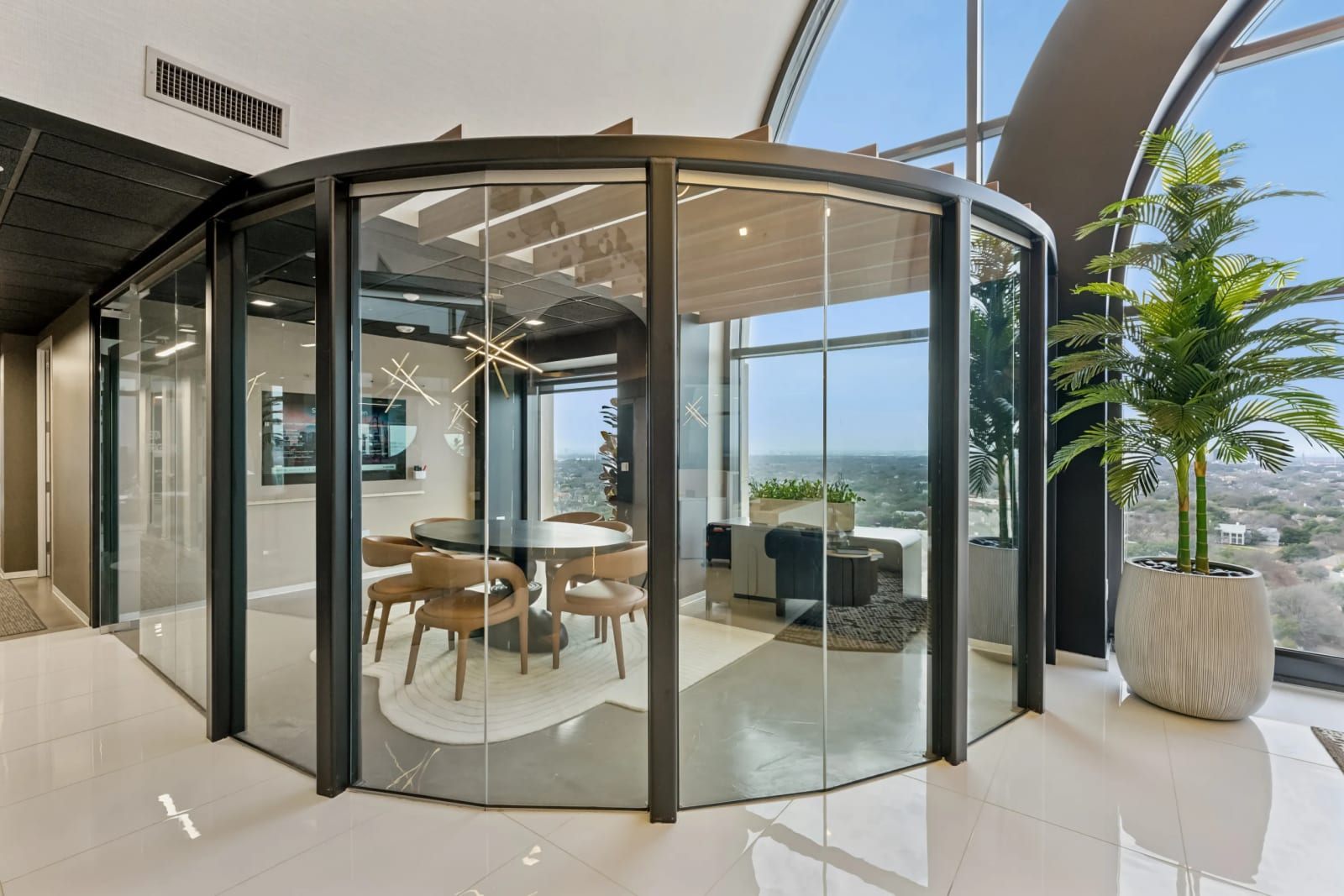 Curved glass-enclosed meeting room in the coworking space at Lucid Private Offices North Central Expressway