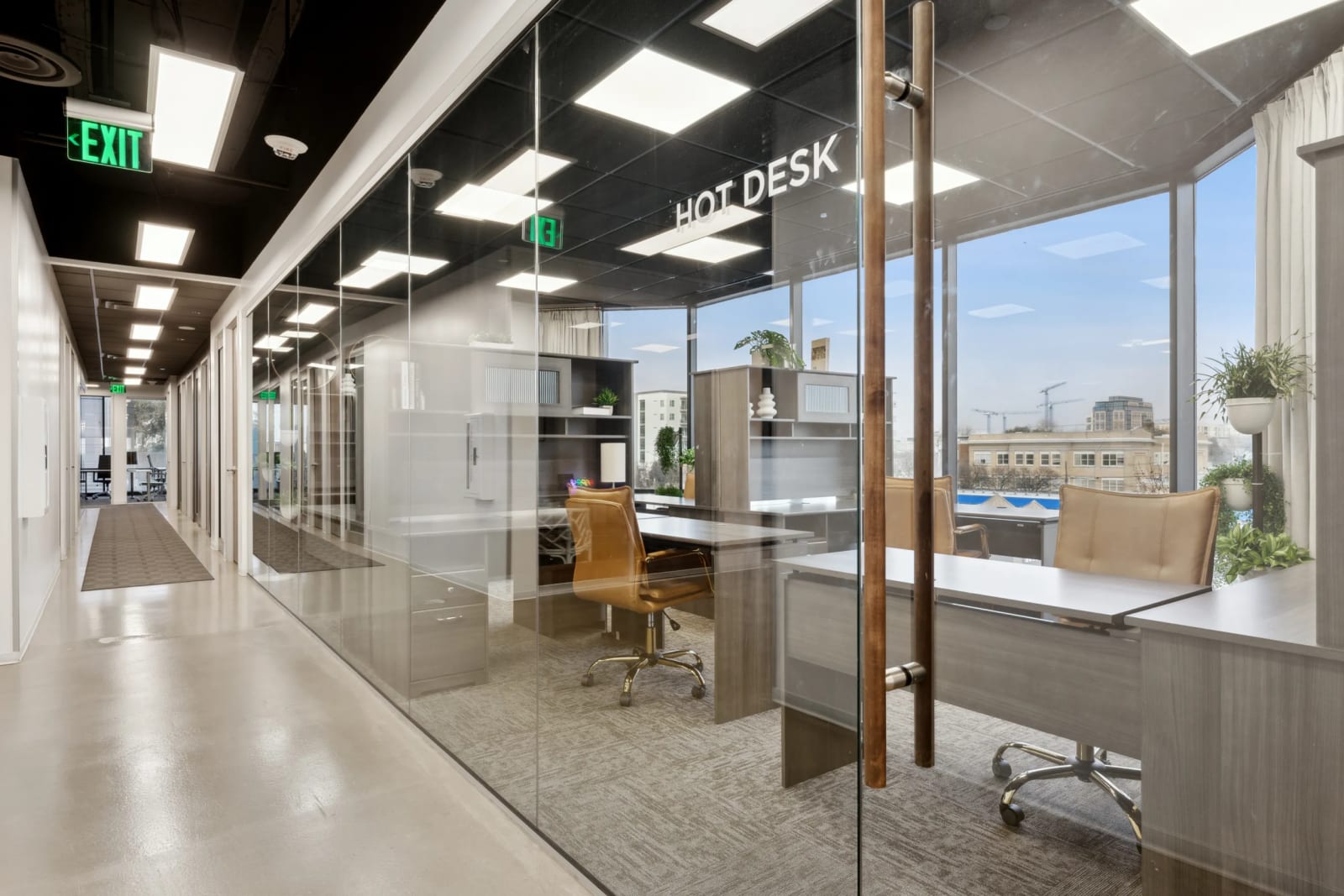 Hotdesk coworking area at Lucid Private Offices Uptown Dallas with open workspace and tall windows