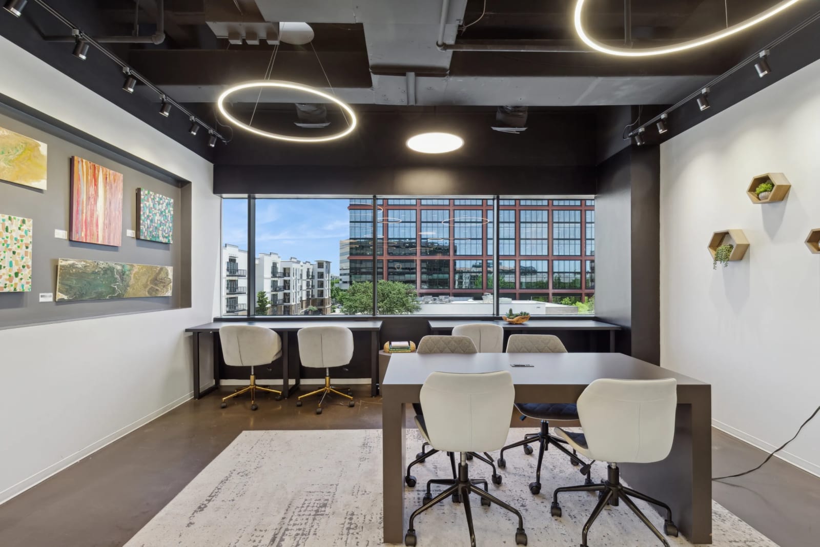 Lucid Private Offices Uptown Dallas meeting room with circular lighting, large windows, and city views