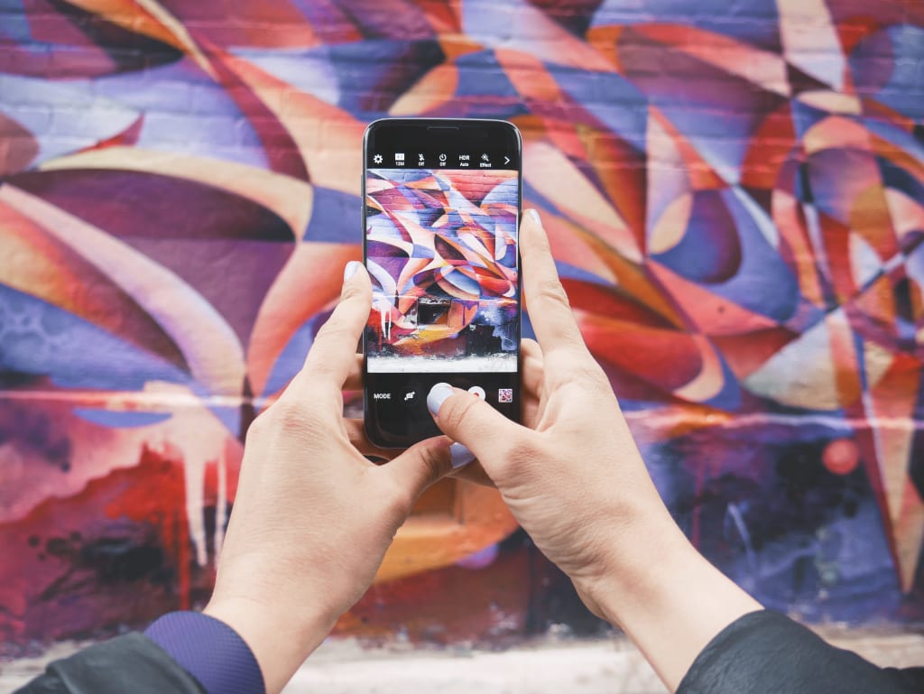 girl using travel app to take a picture in Barcelona, Spain