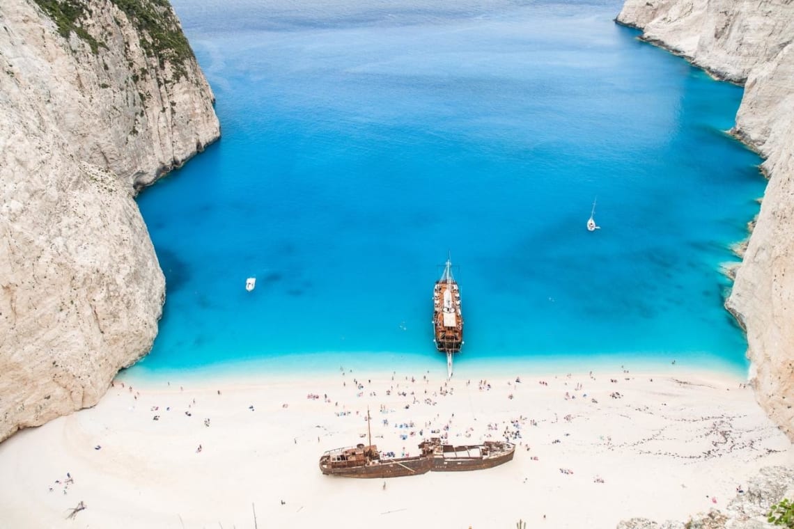Shipwreck on an idyllic Greek beach with blue water