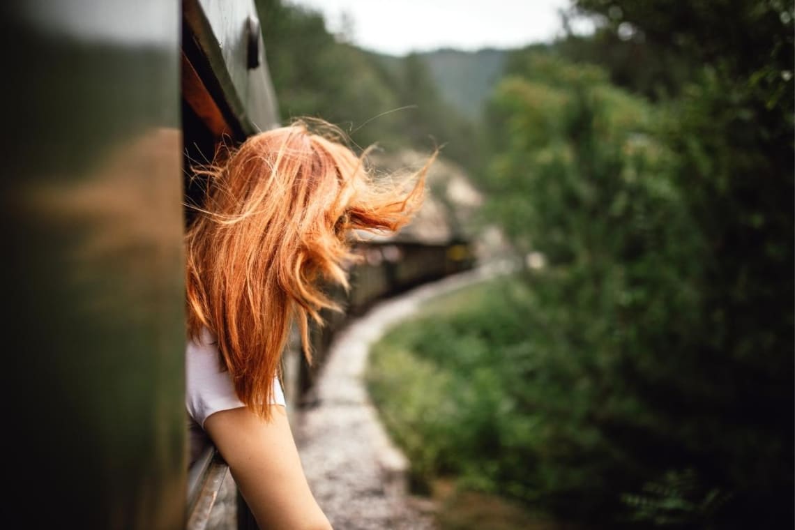 Girl leaning out the train window