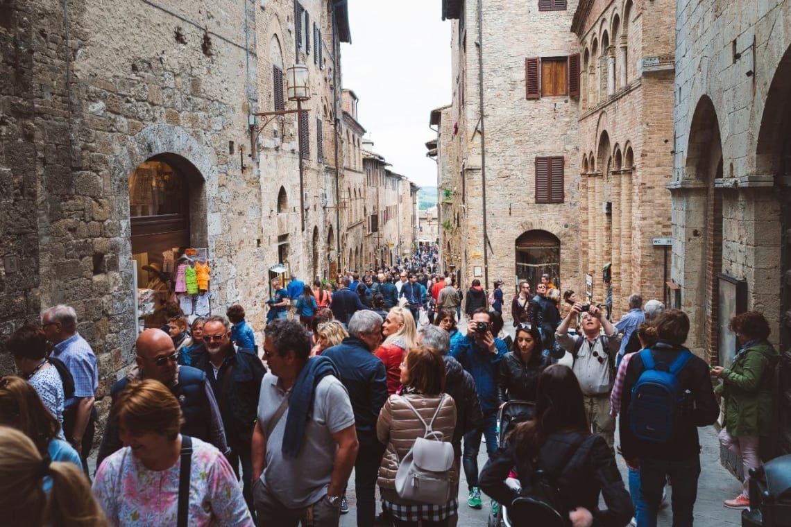 Narrow alley full of tourist in Italy