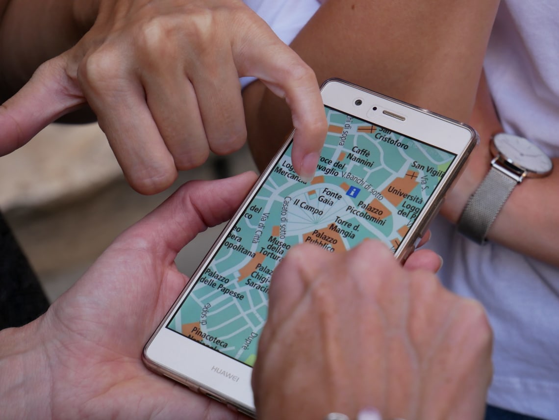 Friends using a travel app to navigate a new city