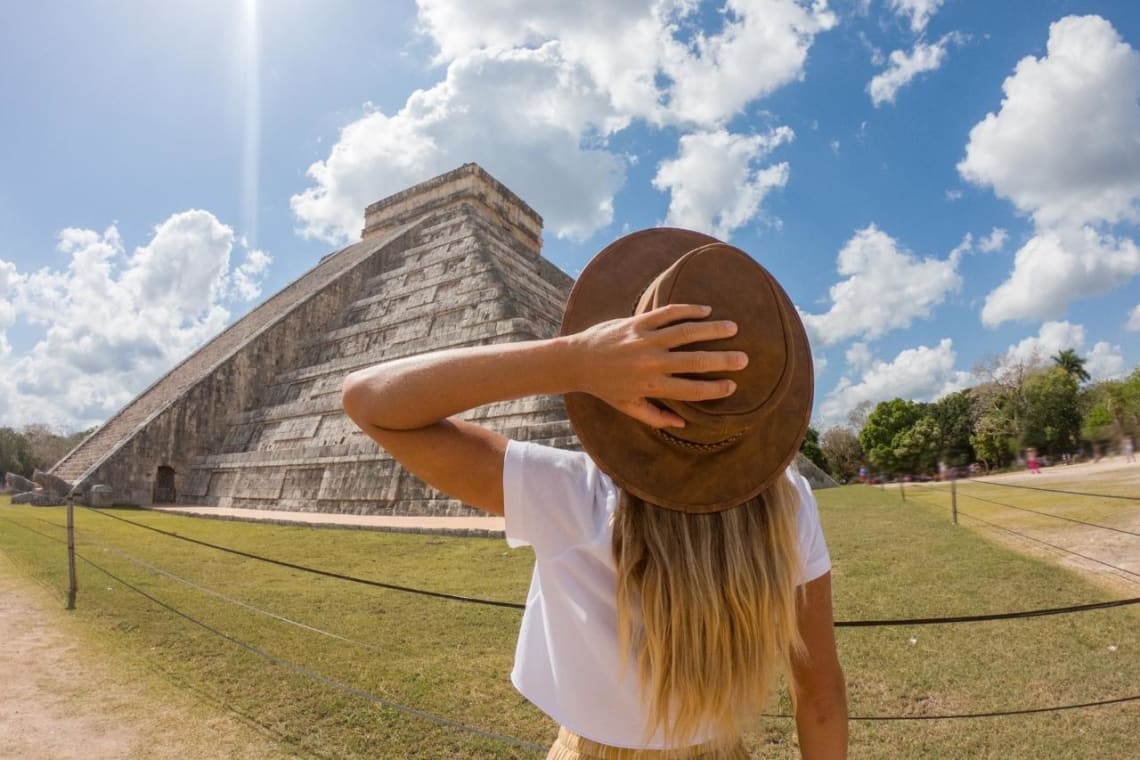 Girl admiring a pyramid on Chichen Itzá