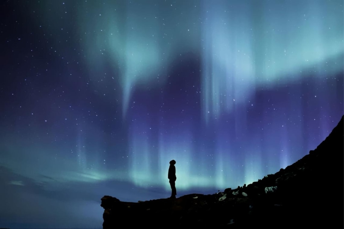 Bucket list adventures: Man looking at the Aurora Borealis