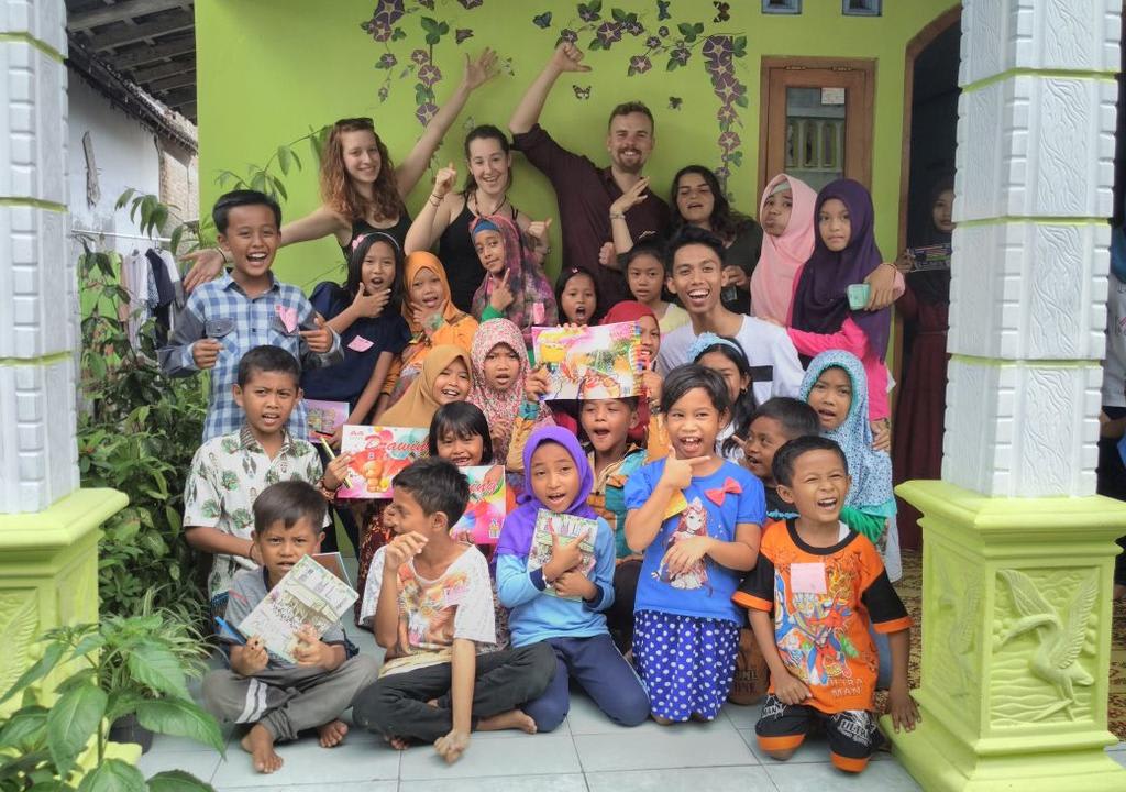 Western volunteers with group of kids from a school in Indonesia