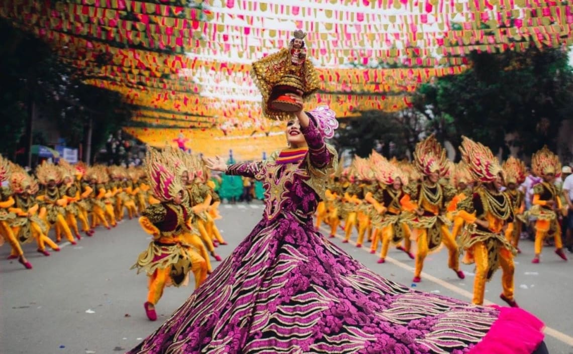 Festival parade with traditional attires in a street of Indonesia