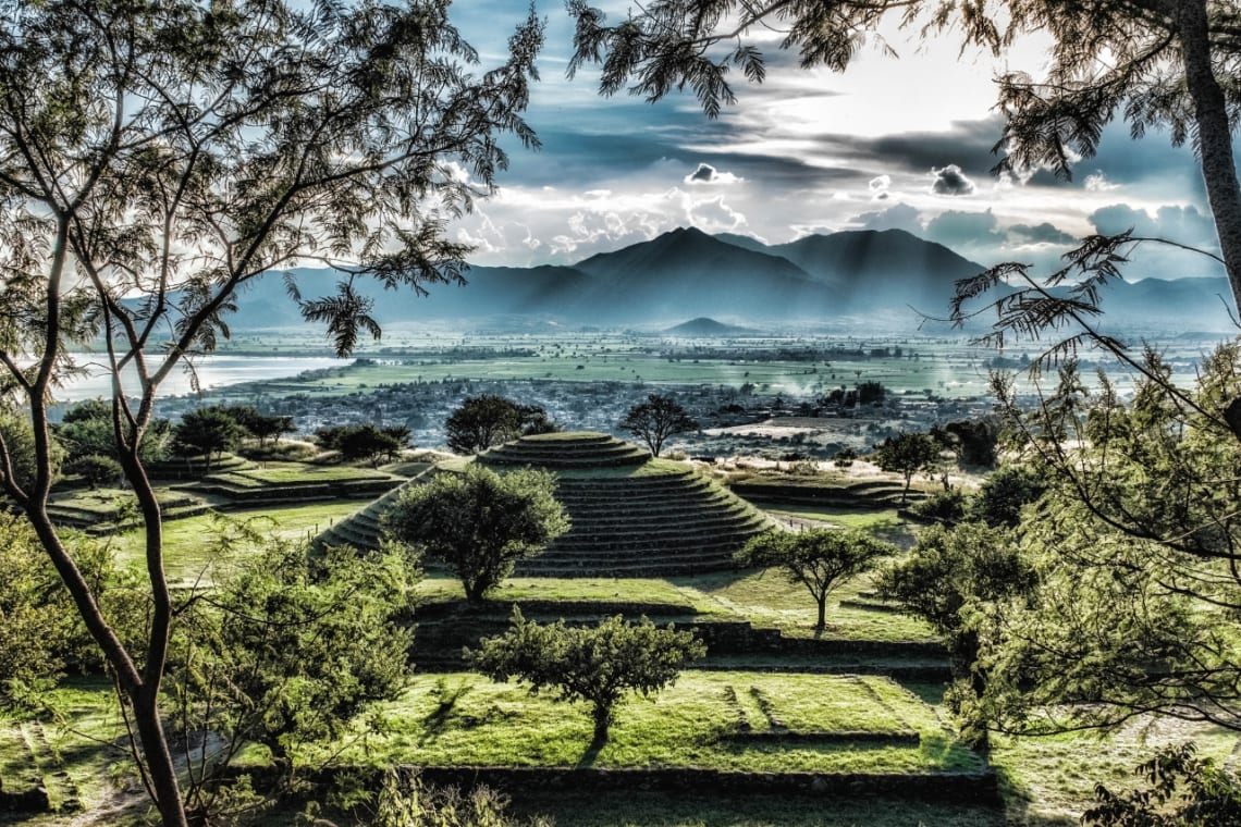 Pyramid at Guachimontones surrounded by nature and mountains as a backdrop