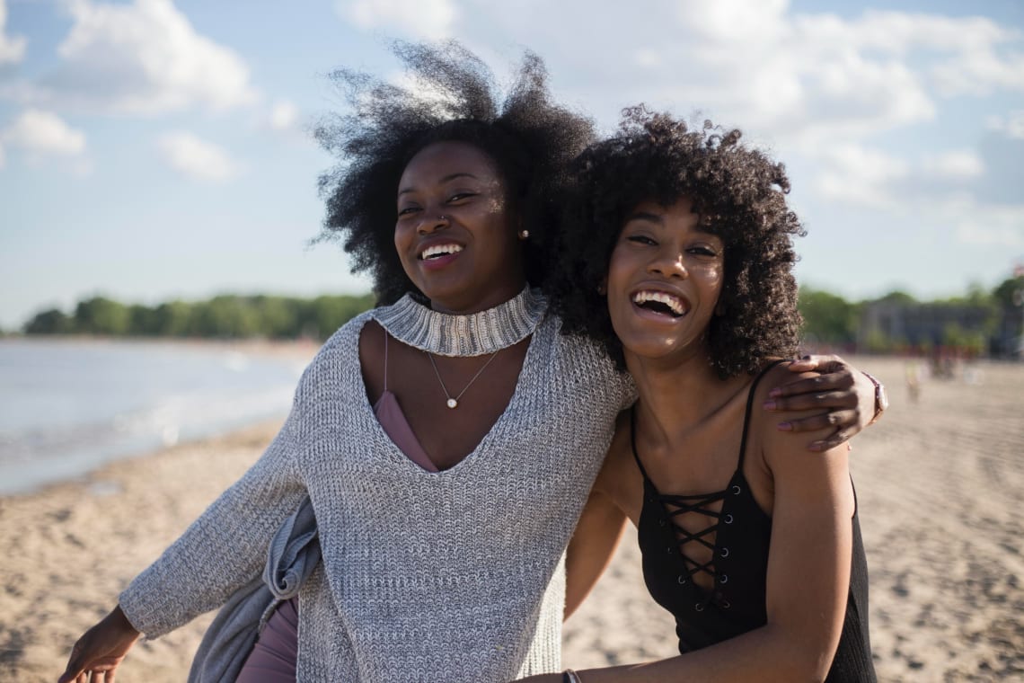 Female travel buddies on a beach