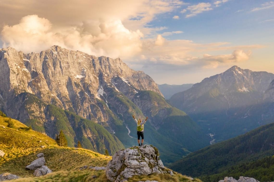 Girl celebrating after a hike in Slovenian mountains