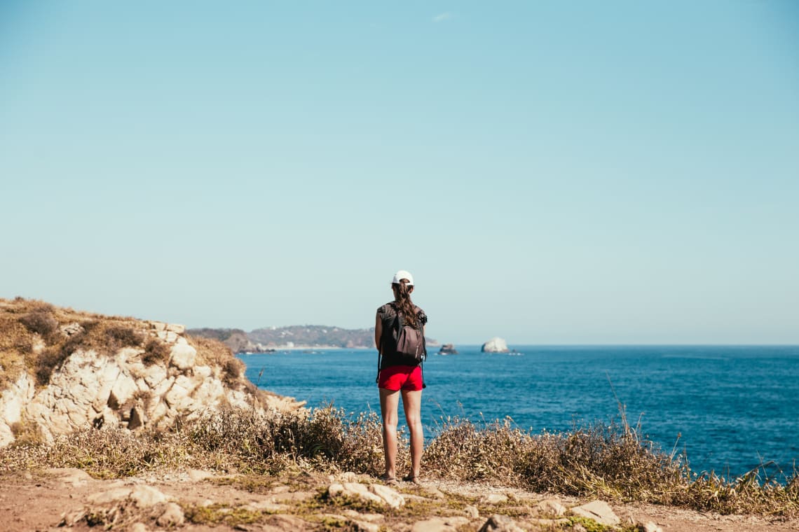 Solo female traveler looking out at the horizon