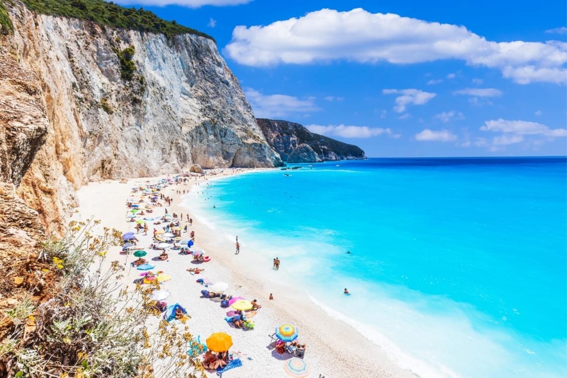 People sunbathing in Lefkada beach, a great Greek island hopping destination