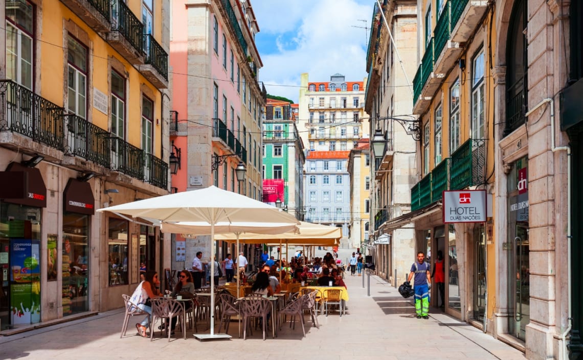 Pedestrian street of Lisbon with tables for eating out