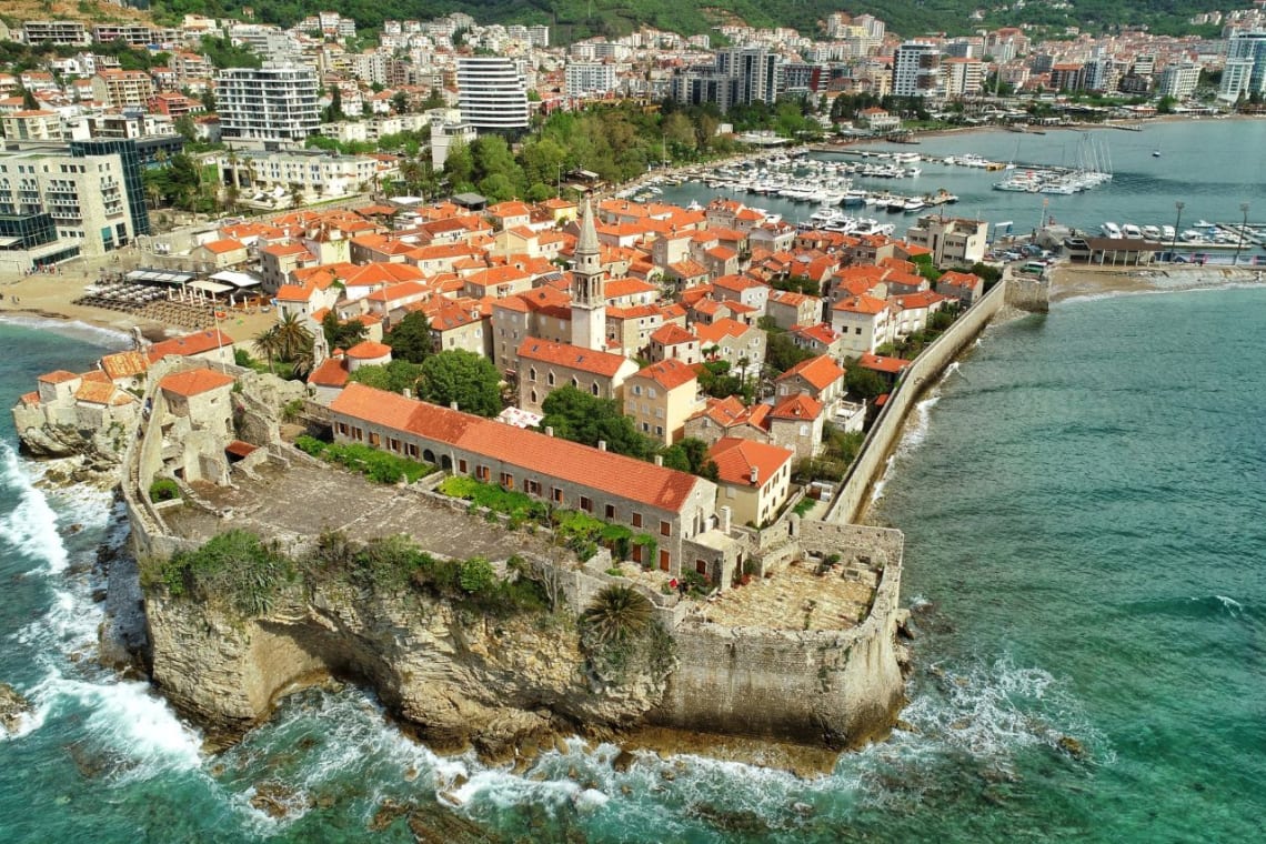 Old town of Kotor in a peninsula over a rough sea