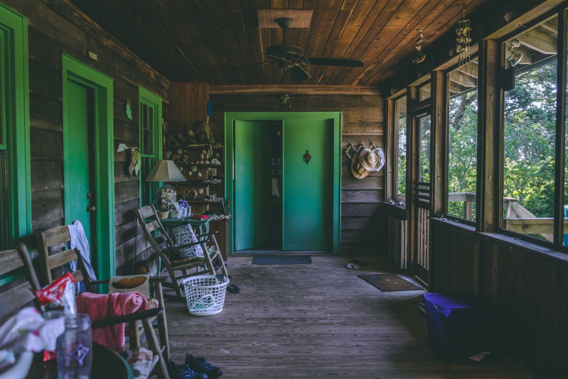 Peaceful hostel porch looking out over expansive greenery